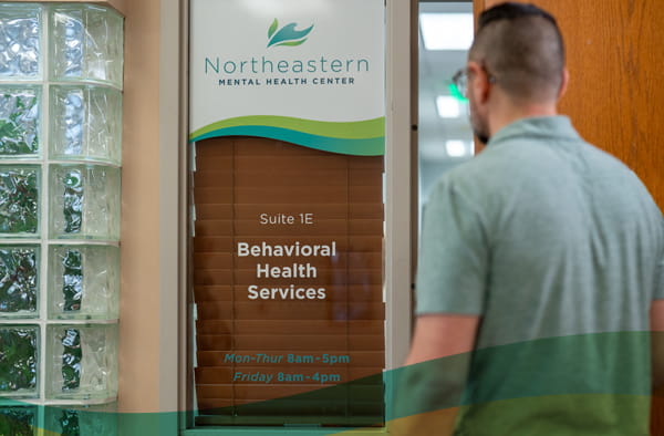 home-wheretostart-min man walking in to office door at north eastern mental health center in aberdeen south dakota